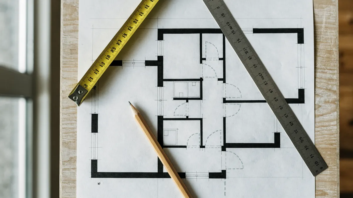 Apartment floor plan drawing with a tape measure, a pencil and a ruler